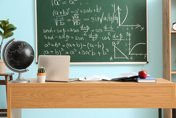 Poster - Table with laptop, books, globe and apple in classroom