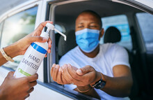 Covid, Cleaning And Hygiene At Drive Thru Testing Centre Or Station For Coronavirus. African Man Driving His Car And Wearing Protective Face Mask To Avoid Contact With Medical Worker