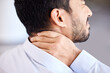 Stress, pain and sore neck closeup of businessman massaging strained muscle. Stressed corporate man suffering from a painful injury rubbing back. Feeling fatigue and unhappy with bad posture
