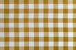 Checkered tablecloth for the table beige and white cells pattern. Background texture of brown textile napkin.