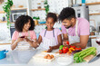 © Graphicroyalty - Family In Kitchen Making Morning Breakfast Together. Happy family in the kitchen having fun and cooking together. Healthy food at home.