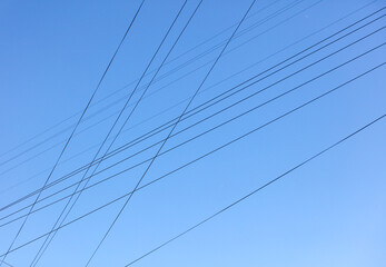 Electric wires against the blue sky. Background