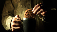 A Soldier In A Camouflage Uniform Soaks A Cookie In A Hot Drink Field Kitchen Making Tea Or Coffee In A Dugout Resting On Duty A Break Between Combat Operations At Night Real Life Footage Close Up