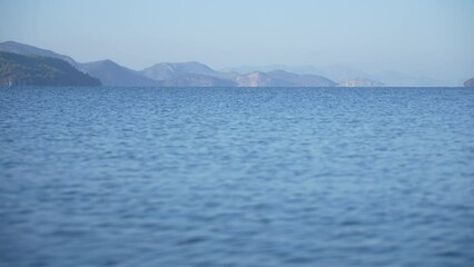 Wall Mural - 4k stock video footage of beautiful peaceful seascape panorama. blue waves of peaceful sea water, cl