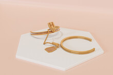 Gold Bracelet Isolated On Pink Background. 3d Rendering