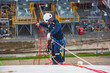 © chitsanupong - Male worker inspection wearing safety first harness rope safety line working at a high place on tank roof spherical gas