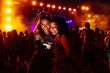 © bernardbodo - Female friends using cellphone at music festival