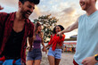 © bernardbodo - Four joyful young friends having fun on their way to the festival venue