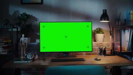 Fototapete - Modern Personal Computer Monitor with Green Screen Mock Up Display Standing on the Desk with Keyboard, Mouse, Pens, Notebooks and Headphones. Cozy Home Office in Loft Living Room Space. Arc Shot.