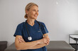 © Friends Stock - Smiling professional woman doctor with stethoscope on her workplace in hospital looking side