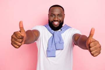Wall Mural - Photo of young good looking positive man show thumb up cheer you up good job isolated on pink color background