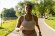 © gpointstudio - Focus African American woman running at the park