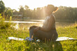 © gpointstudio - African American woman practicing meditating at the park