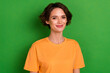 Photo of adorable charming young lady wear orange outfit smiling isolated green color background