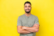 © luismolinero - Young Arab handsome man isolated on yellow background keeping the arms crossed in frontal position