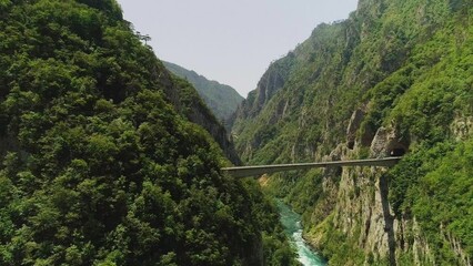 Wall Mural - Aerial video. Shooting a beautiful deep canyon and bridge on a sunny summer day