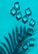 © yanadjan - Ice cubes on a blue background. Selective focus.