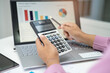 © amazing studio - Asian accountant working and analyzing financial reports project accounting with chart graph in modern office, finance and business concept.