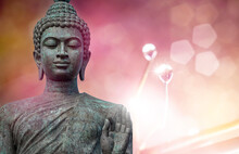 Buddha Statue Made Of Bronze According To The Belief In Buddhism With A Bright Pink Nature Background.