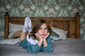cute girl in retro dress lying on the bed