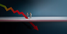 Recession, Inflation And Depression Concepts. Economic Crisis. Graph Fall Down, Business Collapse. Two Miniature Figure Of Businessman Looking At A Red Graph Arrow Down