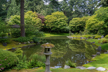 A Japanese Garden Pagoda Statue And Reflection Pond In The Nitobe Memorial Botanical Garden, Vancouver, BC, British Columbia, Canada