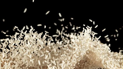 Poster - Rice rises up and falls down. Texture of rice. On a black background. Filmed is slow motion 1000 fps.