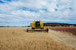 © ADDICTIVE STOCK - Combine harvester driving on agricultural field