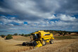 © ADDICTIVE STOCK - Combine harvester in agricultural field