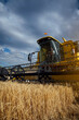 © ADDICTIVE STOCK - Combine harvester in agricultural field