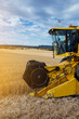 © ADDICTIVE STOCK - Combine harvester in agricultural field
