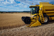 © ADDICTIVE STOCK - Combine harvester in agricultural field