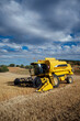 © ADDICTIVE STOCK - Combine harvester in agricultural field