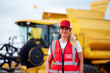 © ADDICTIVE STOCK - Content woman standing near combine harvester