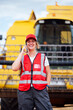 © ADDICTIVE STOCK - Smiling woman having phone call near combine harvester
