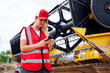 © ADDICTIVE STOCK - Woman having phone call near combine harvester