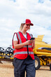 © ADDICTIVE STOCK - Smiling woman having phone call near combine harvester