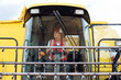 © ADDICTIVE STOCK - Woman driving industrial combine harvester