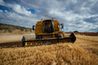© ADDICTIVE STOCK - Combine harvester in agricultural field