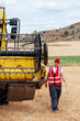 © ADDICTIVE STOCK - Woman checking combine harvester