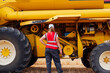 © ADDICTIVE STOCK - Unrecognizable woman checking combine harvester