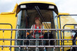 © ADDICTIVE STOCK - Woman driving industrial combine harvester