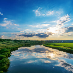 Poster - Amazing sunset in a blue cloudy sky over a river with green banks. Southern Ukraine landscape.