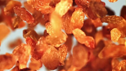 Sticker - Raisins go up and fall down. On a blue background. Filmed is slow motion 1000 fps.