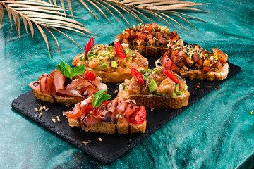 Wall Mural - various bruschettas with toppings on marble. Snack finger food meal for wine, italian starter.