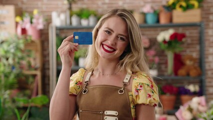 Sticker - Young beautiful hispanic woman florist smiling confident holding credit card at flower shop