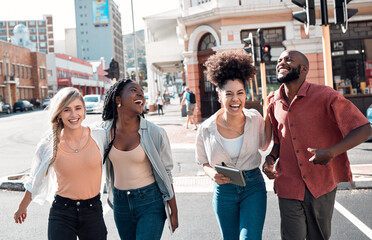 Wall Mural - Happy, young and free trendy friends having fun on a day in the city, laughing while walking and talking together. Diverse group exploring downtown, enjoying their free time on the weekend