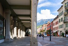 Overhanging Passage On The Right Side And Colorful Sion Street With Picturesque Mountains On The Left