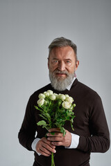 Wall Mural - Grey hair serious man with bouquet of white roses