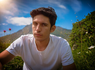 Wall Mural - Half body shot of handsome young man outdoor, looking away